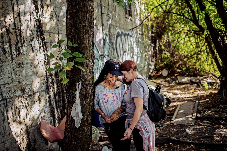 Outreach worker, Kelly Culbert, right, consoles her longtime friend in the Bronx. Photo credit: Ryan Christopher Jones